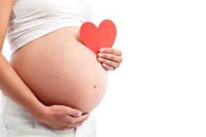 Pregnant's woman belly with heart