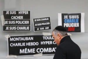 A man pays tribute to the victims of a hostage taking at the Hyper Cacher kosher supermarket near Porte de Vincennes in eastern Paris