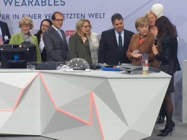 Angela Merkel looks at Bragi Dash